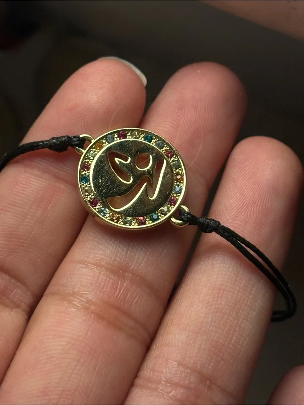 Zumba Fitness Gold Om Pendant Bracelet with Multicolor Crystals and Black Cord